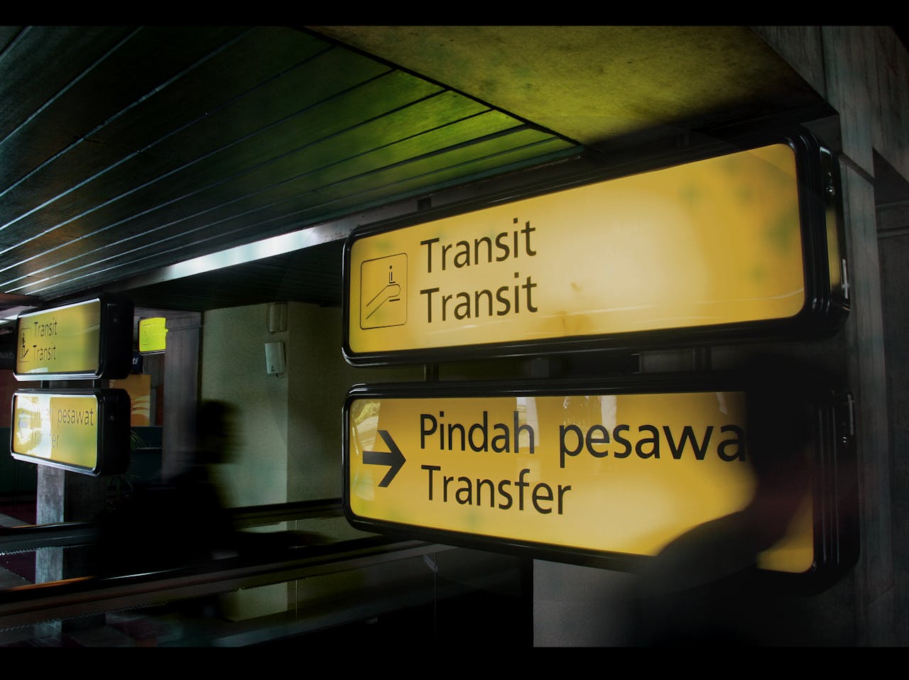 about-us-02 Illuminated transit signs at an airport in Banten, Indonesia, guiding passengers.
