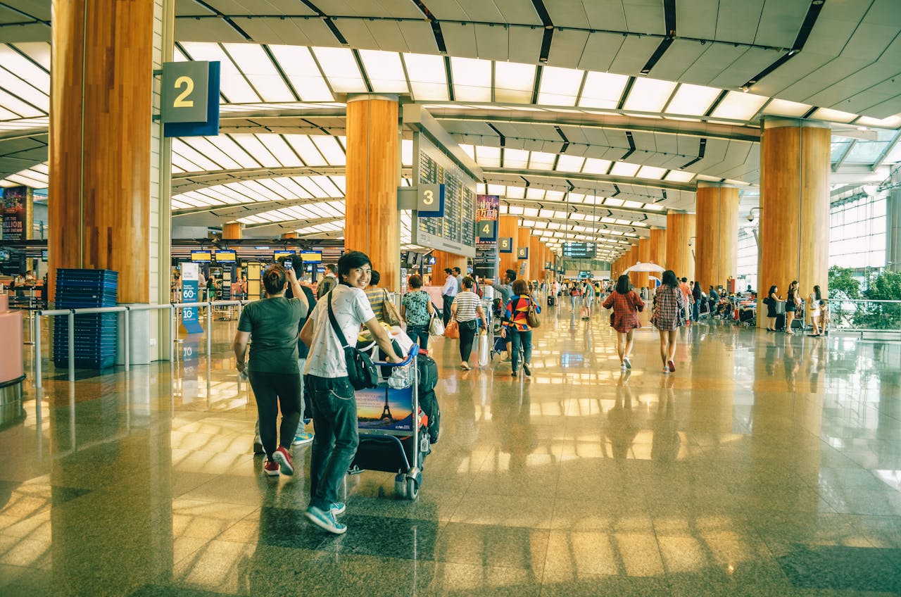 about-us-01 Travelers bustling through Singapore Changi Airport terminal, highlighting the dynamic and vibrant atmosphere of international travel.